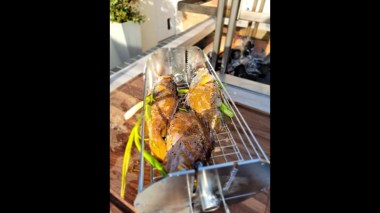 Argentinian Style Grill cooking gopher cod on a Rotisserie