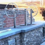Stationary Outdoor Kitchen Island wood burning grill. Stainless dual crank Argentinian style Santa Maria Gaucho Grill.