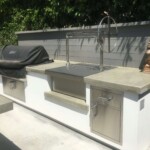 Stainless steel built in grill next to a gas grill is the perfect compliment.