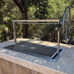 Stainless Santa Maria Grill insert installed in an outdoor kitchen.