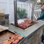 Charcoal grill with Argentine grill design for cooking with wood or bagged charcoal.